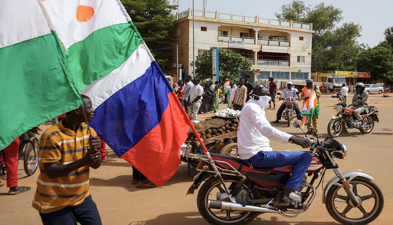 Ένας διαδηλωτής επιδεικνύει τις σημαίες του Νίγηρα (επάνω) και της Ρωσίας κατά τη διάρκεια διαδήλωσης κατά του γαλλικού στρατού στο Νιαμέι, Νίγηρας © EPA/ISSIFOU DJIBO